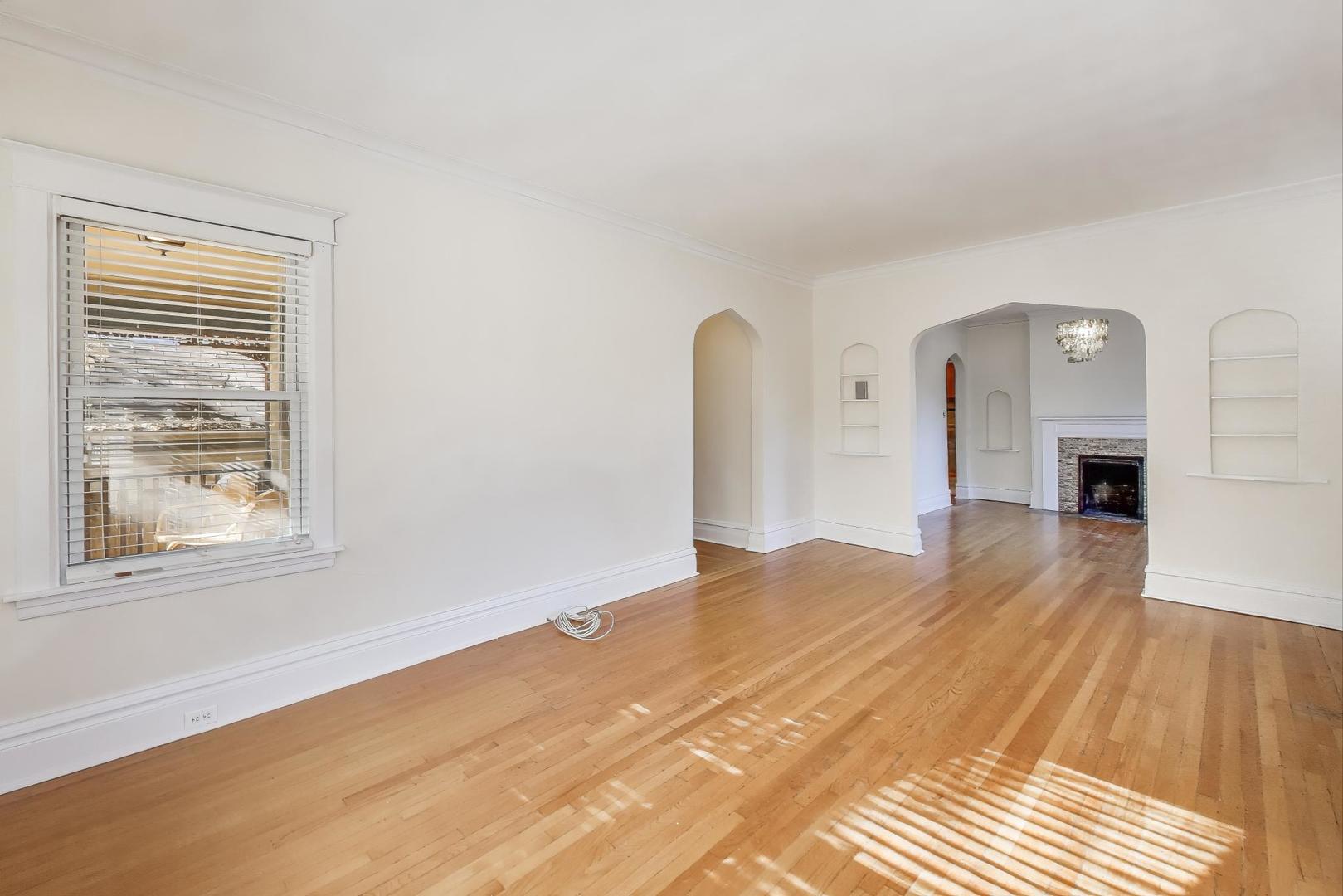 916 Pleasant Street, Unit 1 Oak Park, IL 60302 - Photo 6 of 23 a bedroom with a bed and a flat screen tv