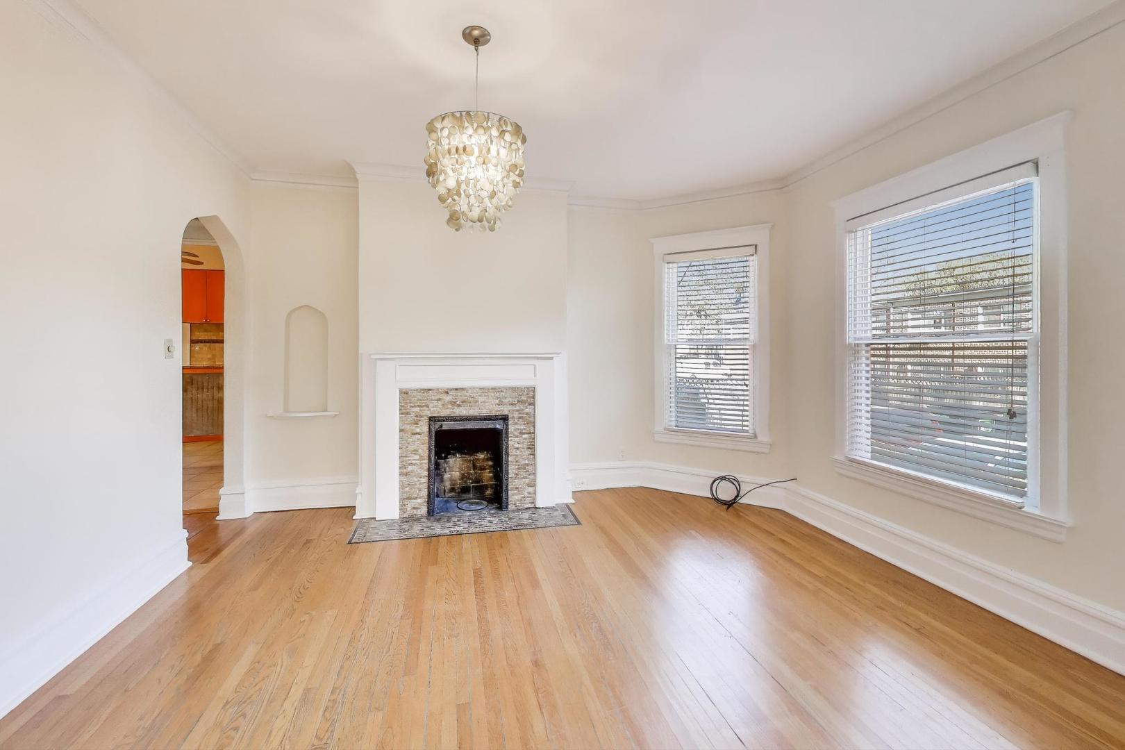 916 Pleasant Street, Unit 1 Oak Park, IL 60302 - Photo 7 of 23 a view of an empty room with wooden floor and a window
