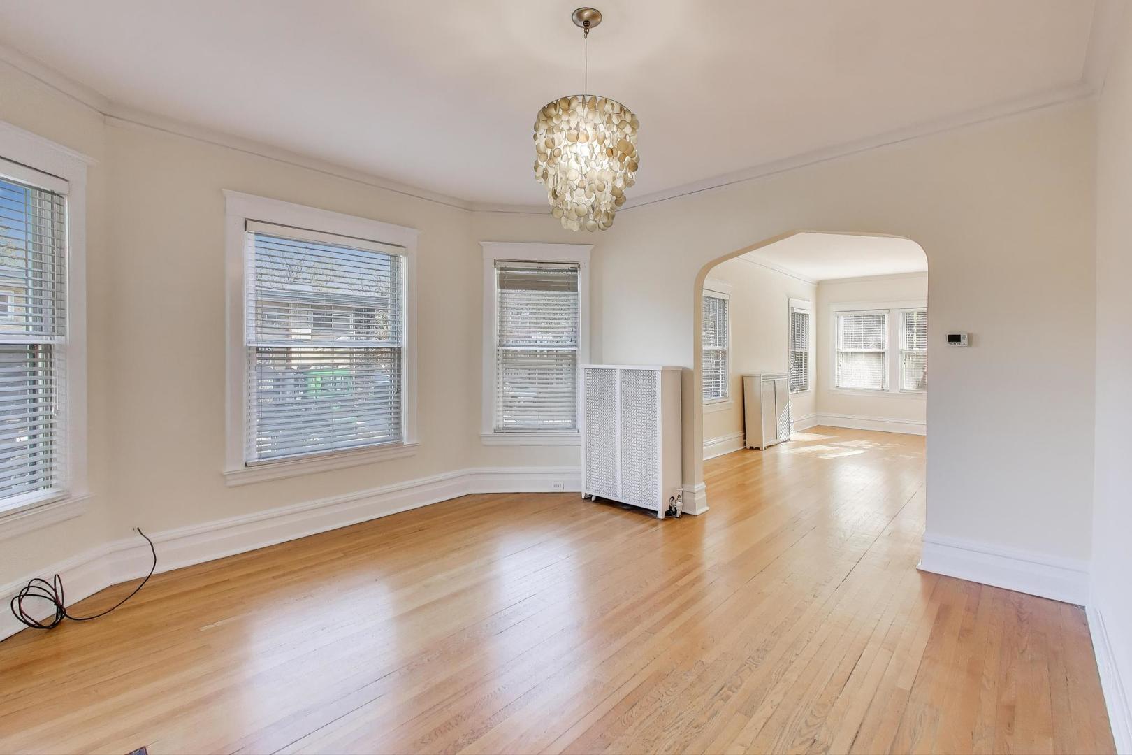 916 Pleasant Street, Unit 1 Oak Park, IL 60302 - Photo 8 of 23 a view of an empty room with wooden floor and a window