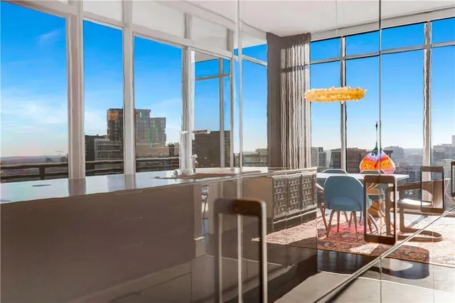 a living room with stainless steel appliances kitchen island granite countertop a sink and cabinets