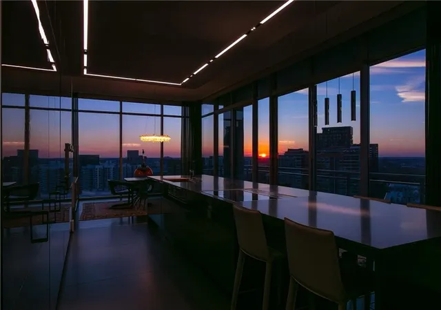 a room with furniture and view of kitchen