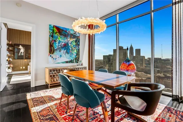 a living room with couches a coffee table and a table with garden view