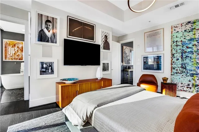 a bedroom with a bed and a painting on the wall