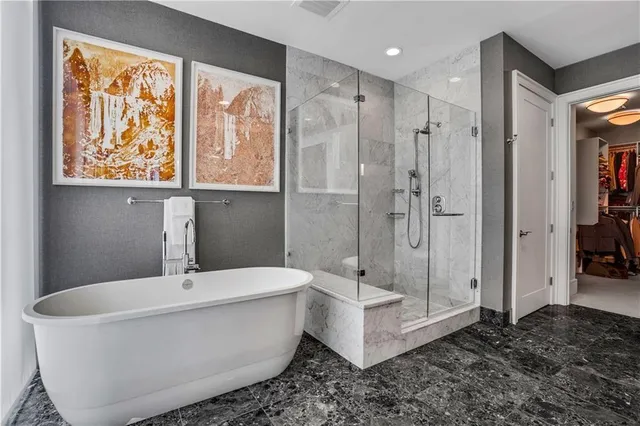 a bathroom with a granite countertop toilet sink and mirror