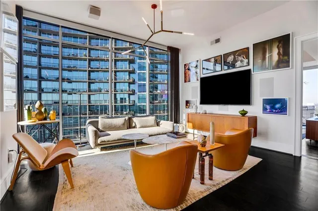 a living room with furniture workspace and a flat screen tv
