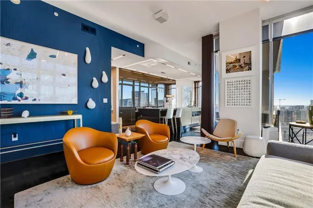 a dining hall with stainless steel appliances granite countertop a stove a sink and a refrigerator