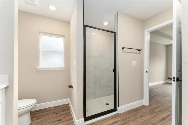 a bathroom with a glass door shower