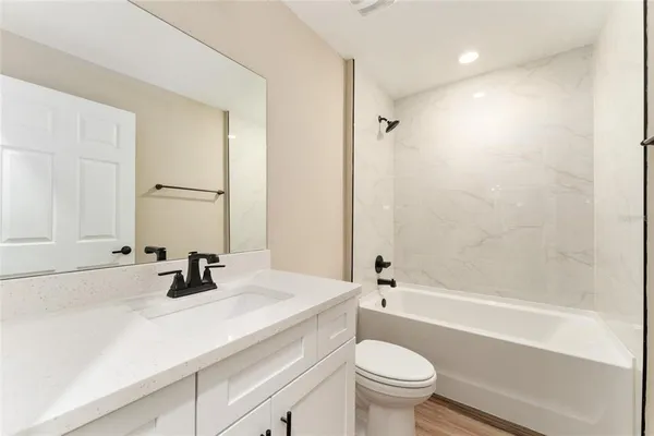a bathroom with a sink a toilet and a bathtub