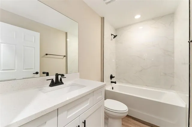 a bathroom with a sink a toilet and a bathtub