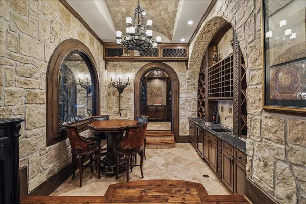 a view of a dining room with furniture and chandelier