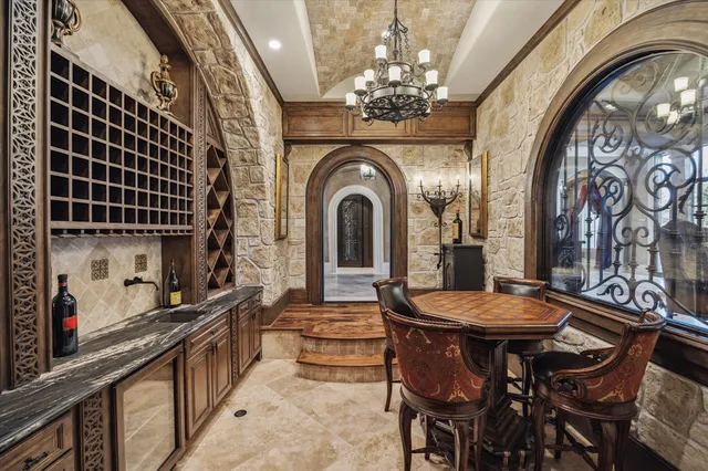 a view of a dining room with furniture and chandelier