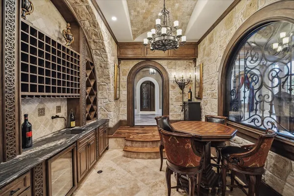 a living room with furniture gym equipment and a chandelier