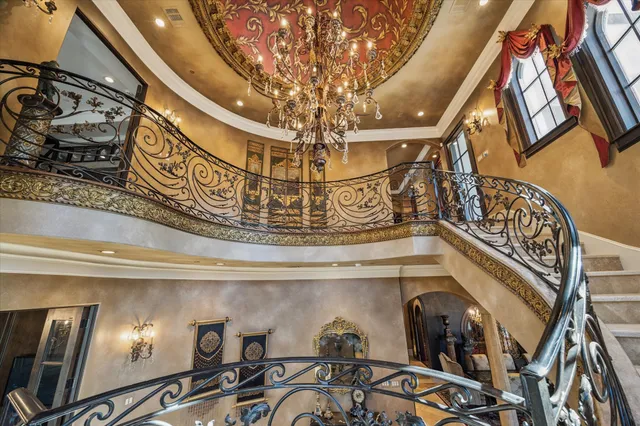 a view of a dining room with furniture and chandelier