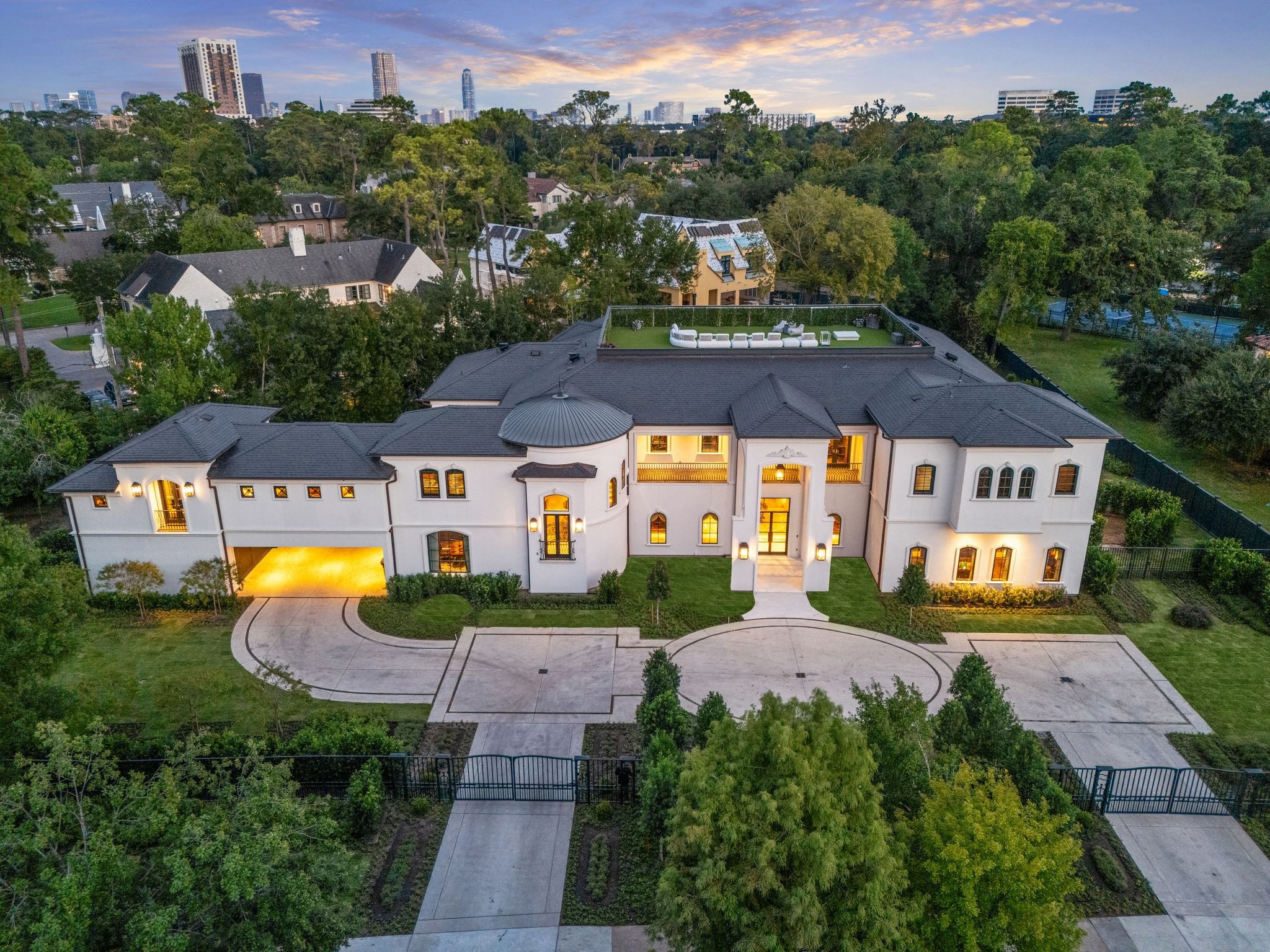 11095 Memorial Drive Houston, TX 77024 - Photo 2 of 48 An aerial view highlights the home’s freshly painted French Mediterranean façade, circular drive with brand-new concrete, and manicured landscaping on its private 1.2-acre setting along iconic Memorial Drive.