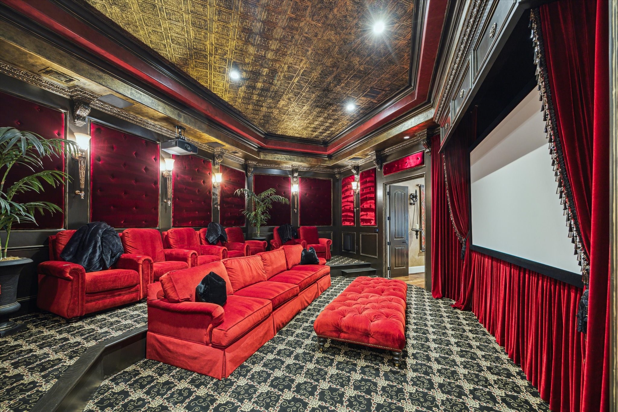 11095 Memorial Drive Houston, TX 77024 - Photo 25 of 48 Watch cinema in style -- this luxurious home theater features custom black & gold patterned carpet flooring and a showstopping 13-ft double-trayed ceiling, adorned with ornate tin ceiling tiles and intricate crown molding with corbels.