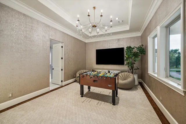 a living room with furniture and a chandelier