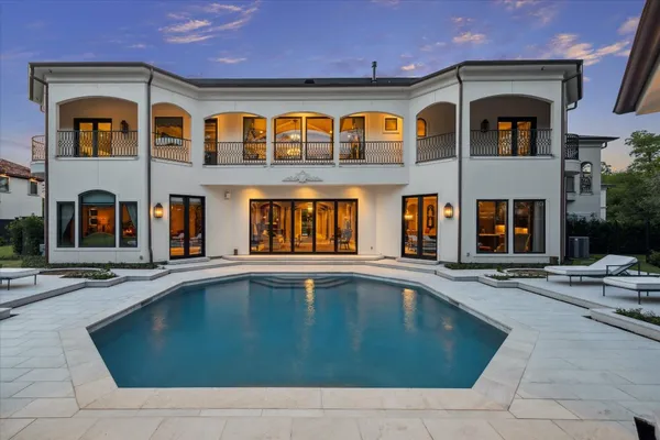 an aerial view of a house with outdoor space pool seating area and yard