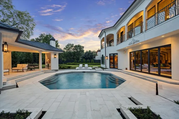 an aerial view of a house with a garden and swimming pool