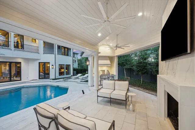 a view of a patio with lawn chairs next to a yard