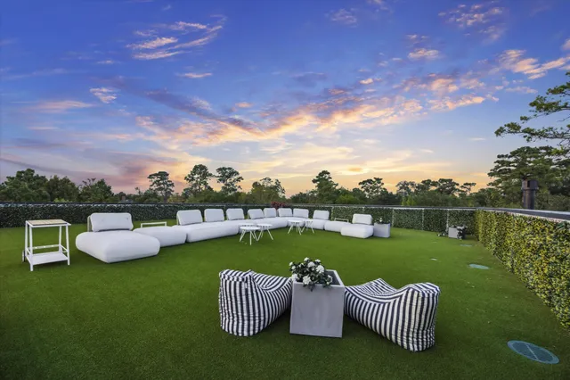an aerial view of a house with a garden and swimming pool