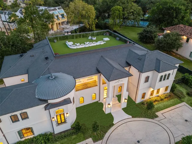 an aerial view of a house with a garden house swimming pool and outdoor seating