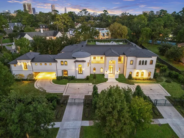 a front view of a house with a yard and plants