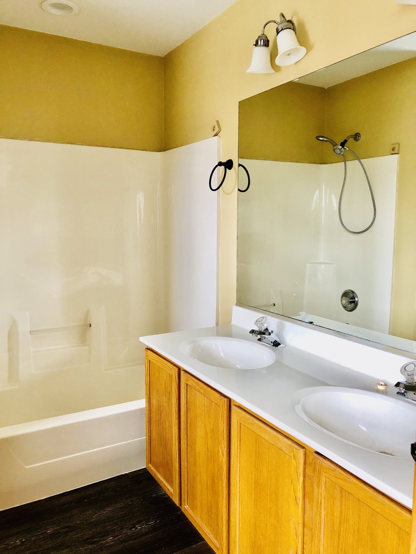 1675 Kautz Road Aurora, IL 60504 - Photo 15 of 57 a bathroom with a granite countertop sink and a mirror