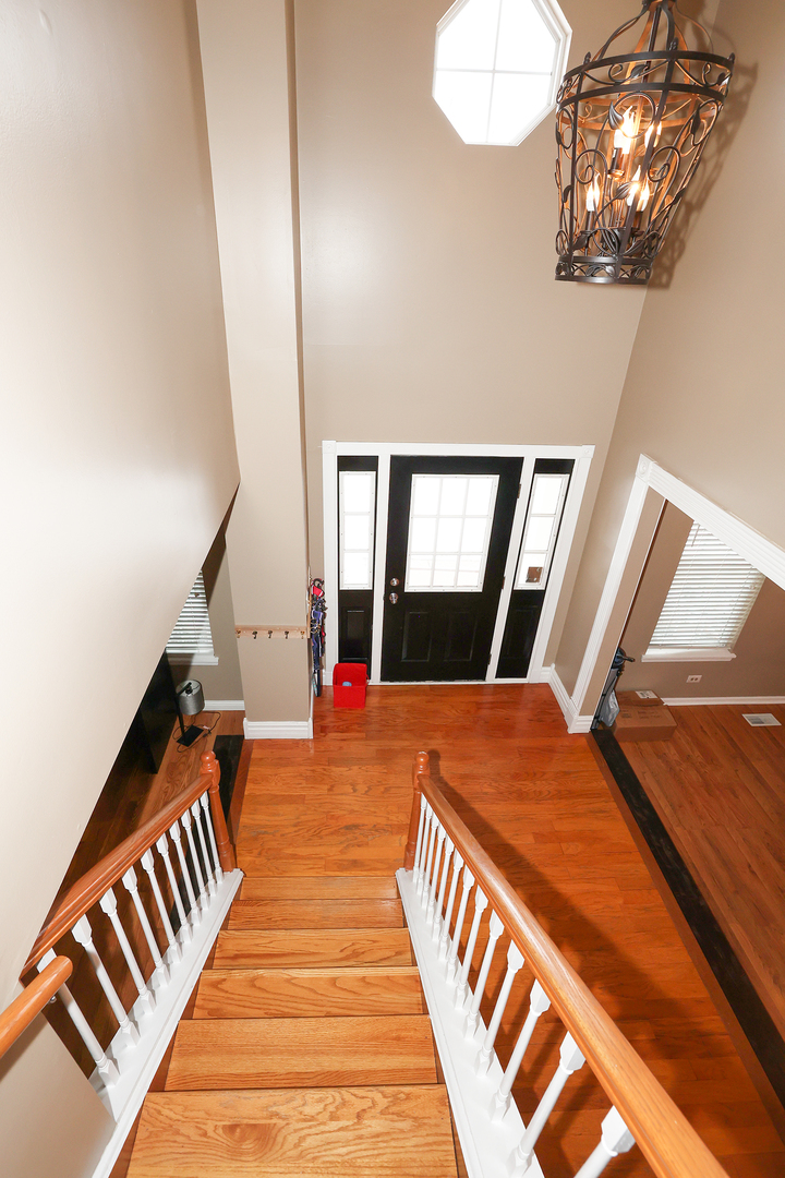 1675 Kautz Road Aurora, IL 60504 - Photo 18 of 57 a balcony with wooden floor and chandelier