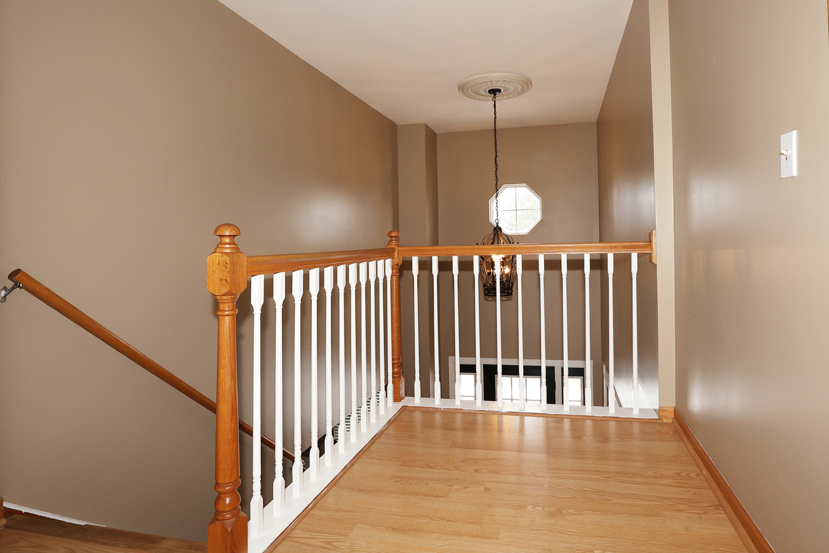 1675 Kautz Road Aurora, IL 60504 - Photo 26 of 57 a view of a hallway with wooden floor and a chandelier