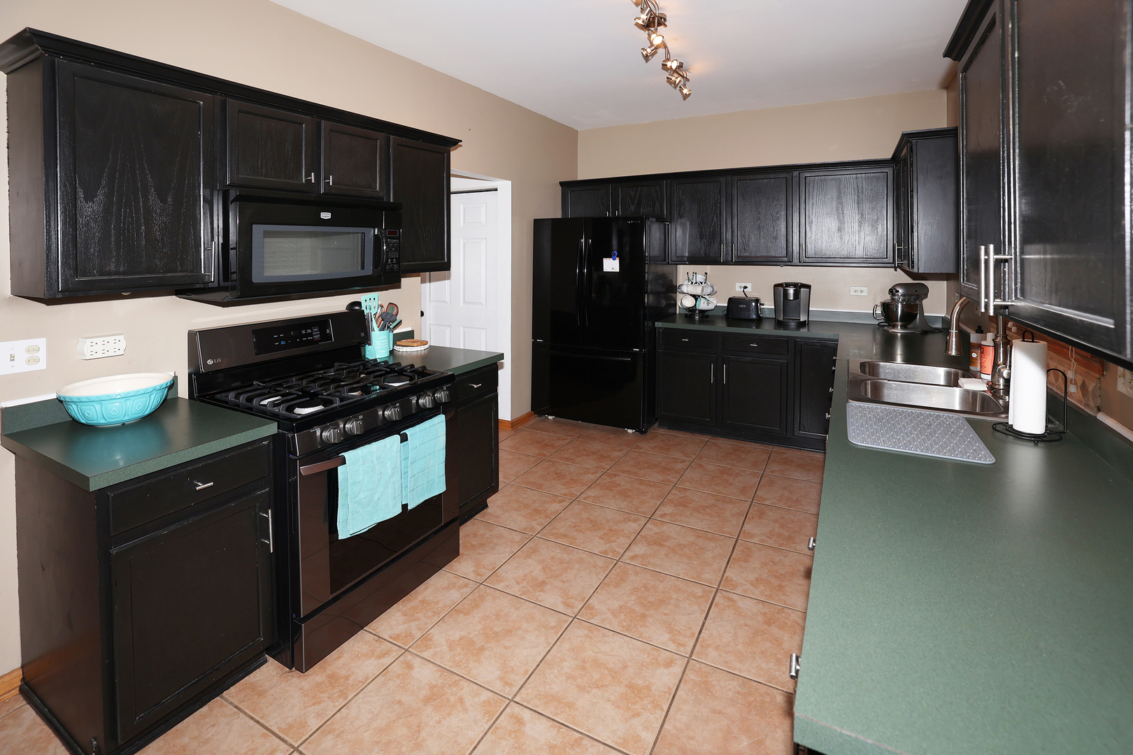 1675 Kautz Road Aurora, IL 60504 - Photo 39 of 57 a kitchen with granite countertop a stove a sink a microwave and cabinets