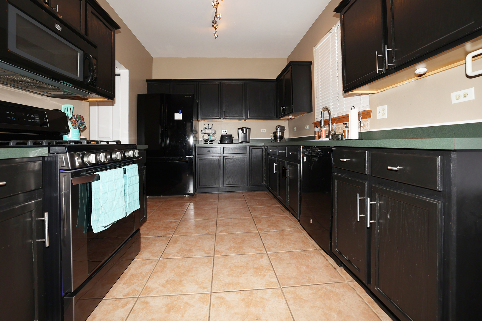 1675 Kautz Road Aurora, IL 60504 - Photo 40 of 57 a kitchen with stainless steel appliances granite countertop a stove a sink and a refrigerator
