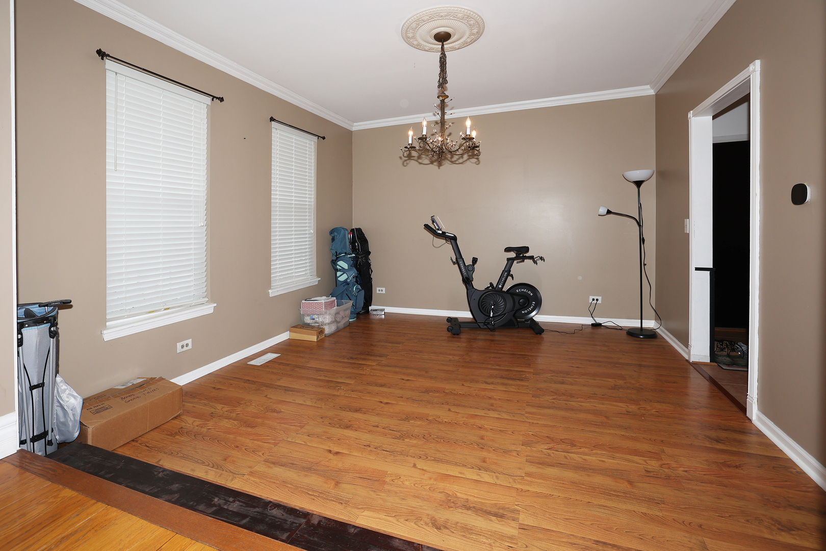 1675 Kautz Road Aurora, IL 60504 - Photo 51 of 57 a bedroom with a bed and a chandelier