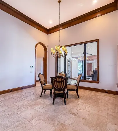 a dining room with furniture and a chandelier