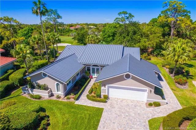 a aerial view of a house with a yard and potted plants