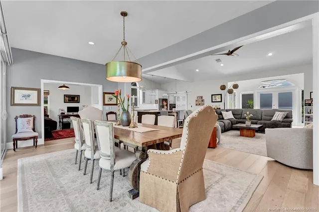 a dining room with furniture a chandelier and window
