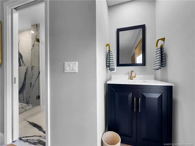 a bathroom with a sink and a mirror