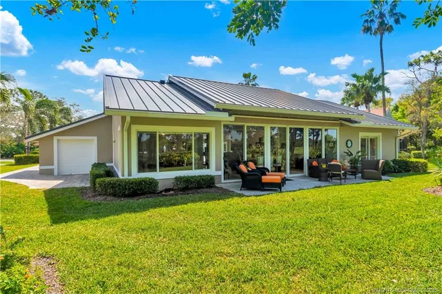 a view of a house with backyard porch and sitting area