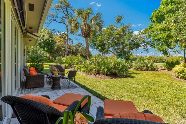 a view of yard from deck having patio
