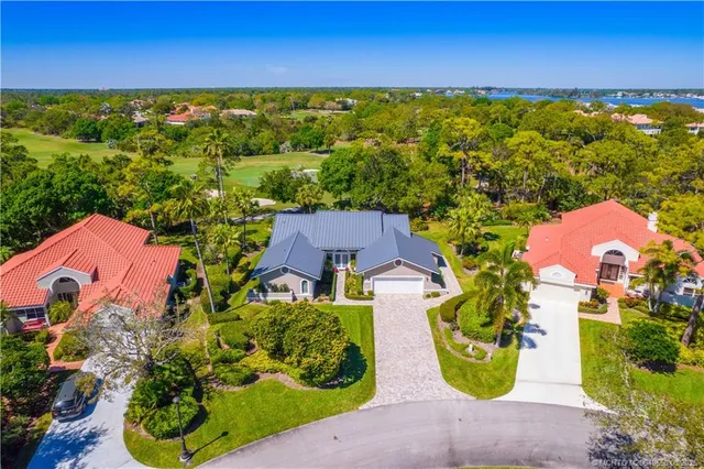 an aerial view of a house with a yard and lake view