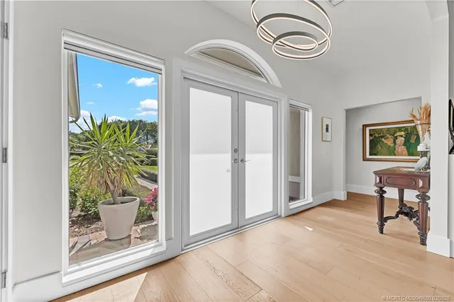 a view of a hallway with a potted plant on a table