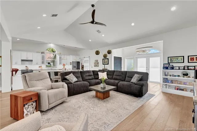 a living room with furniture and view of kitchen
