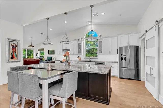 a kitchen with granite countertop a sink appliances and cabinets