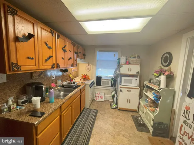 a kitchen with a sink stove and wooden cabinets