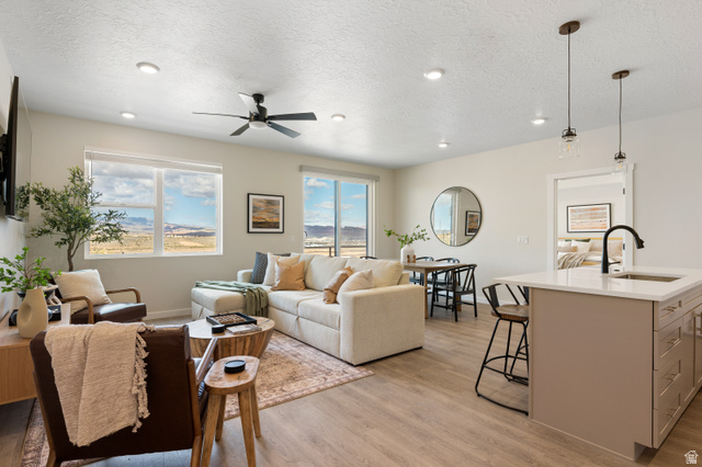 961 West Akoya Pearl Road, Unit 301 St. George, UT 84790 - Photo 2 of 22 Living room featuring a textured ceiling, light wood-type flooring, plenty of natural light, recessed lighting, and a ceiling fan