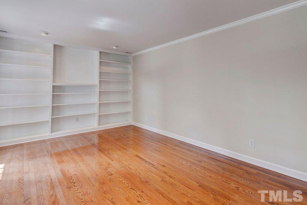 4408 Pamlico Drive Raleigh, NC 27609 - Photo 3 of 20 a view of a room with wooden floor and shelf