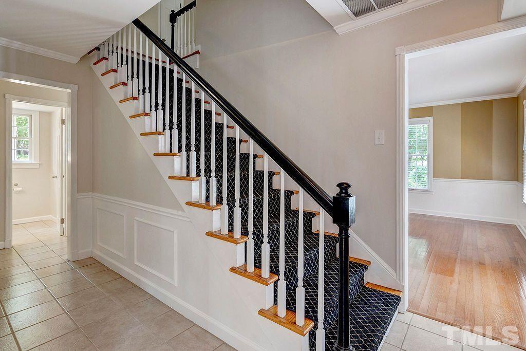 4408 Pamlico Drive Raleigh, NC 27609 - Photo 4 of 20 a view of staircase with wooden floor and a rug
