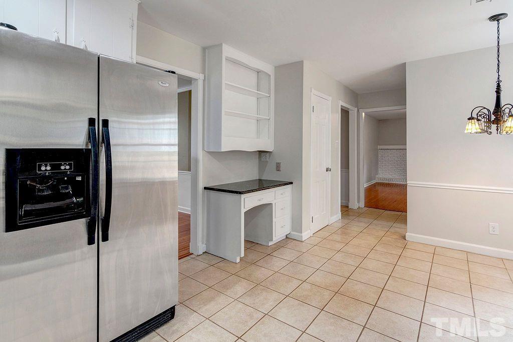 4408 Pamlico Drive Raleigh, NC 27609 - Photo 9 of 20 a kitchen with white cabinets and refrigerator