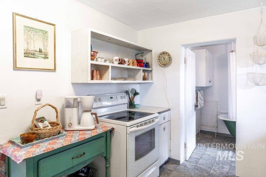 1755 Genesee Troy Road Moscow, ID 83843 - Photo 49 of 50 Kitchen with white range with electric stovetop, green cabinets, and light countertops