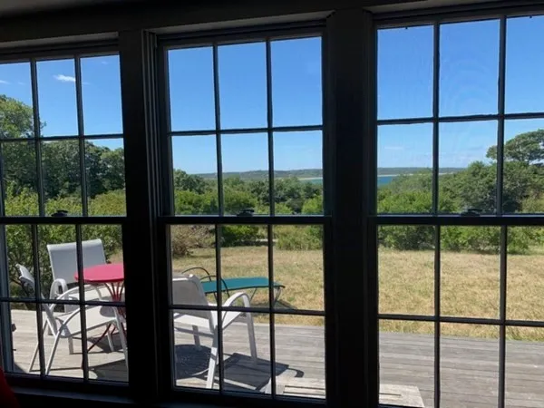 a kitchen with granite countertop white cabinets and window