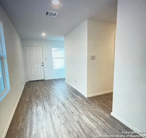 a view of a room with wooden floor